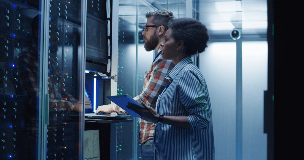 man and woman working side by side in server room