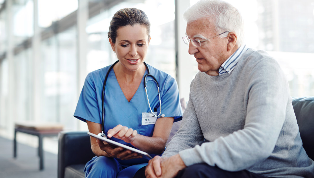 Cropped shot of a female nurse showing her patient something on a digital tablet